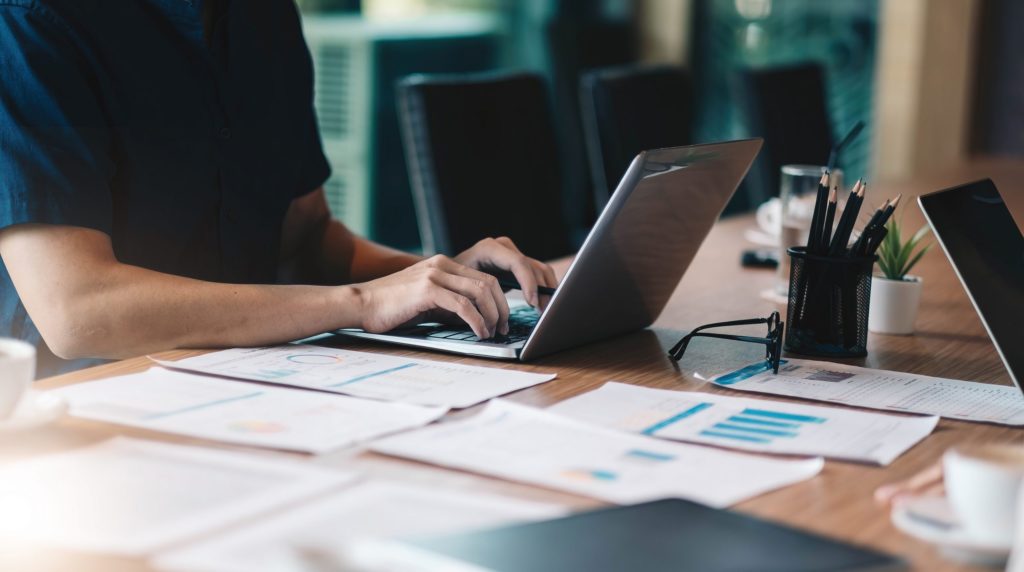 man working in finance and accounting Analyze financial budget at office.