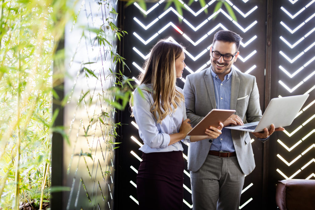 Happy business colleagues at meeting in modern office interior